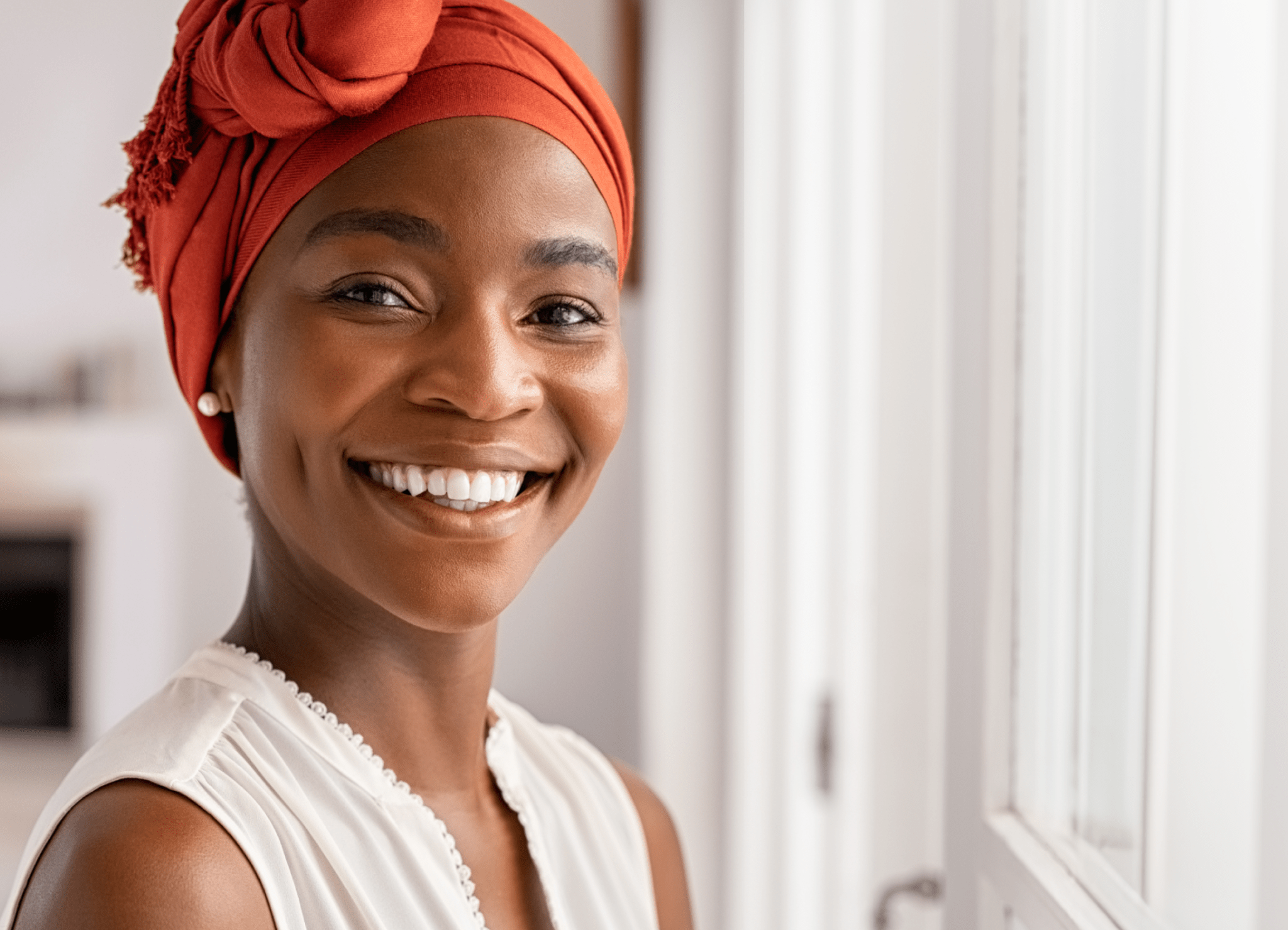 Actor Portrayal; A young Southeast Asian adult woman, in a floral top, slightly smiling while contemplating cervical cancer and HPV infections in women.